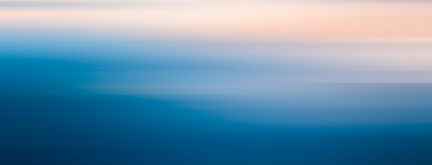 Abstract gradient blending from light peach to deep blue, creating a serene visual effect.