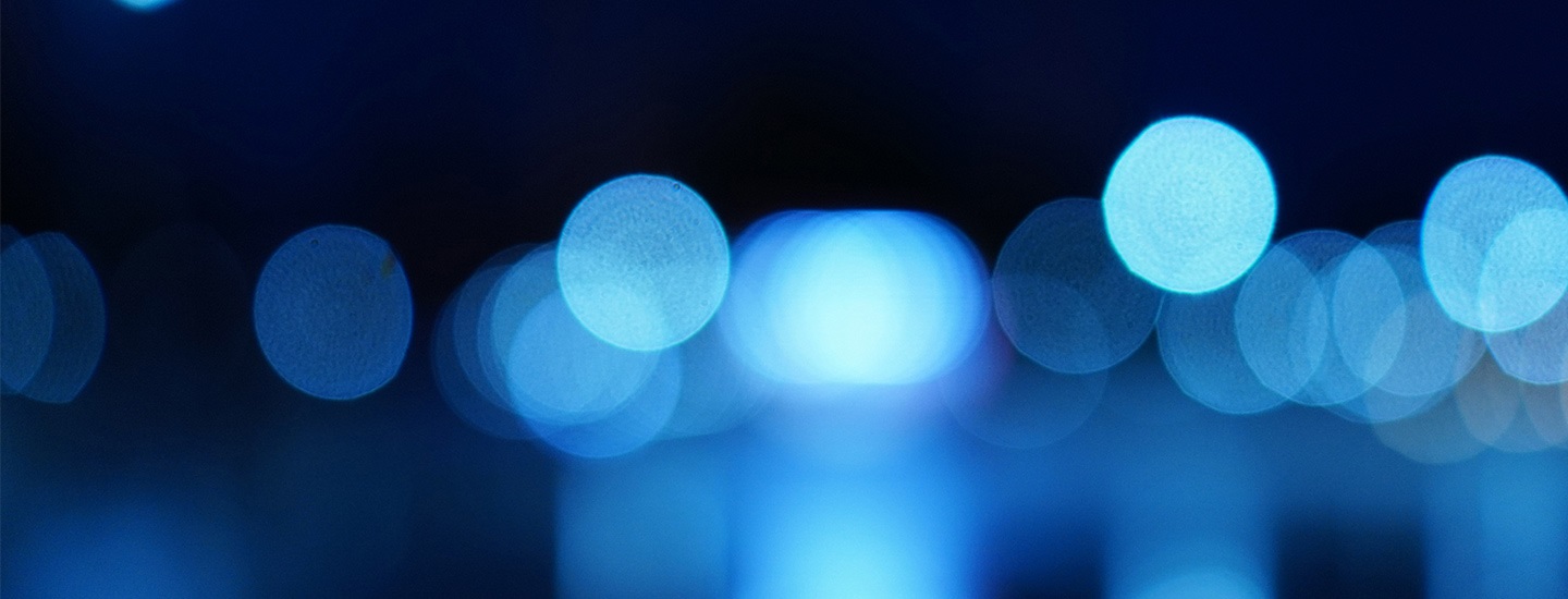 Abstract image with blue bokeh lights on a blurred background.