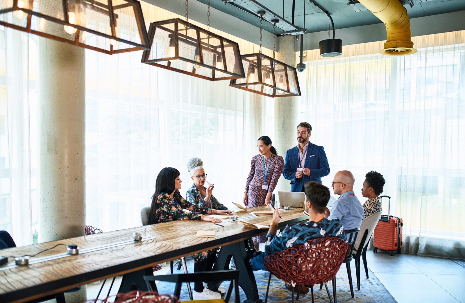 People seated around a table in a modern conference room.