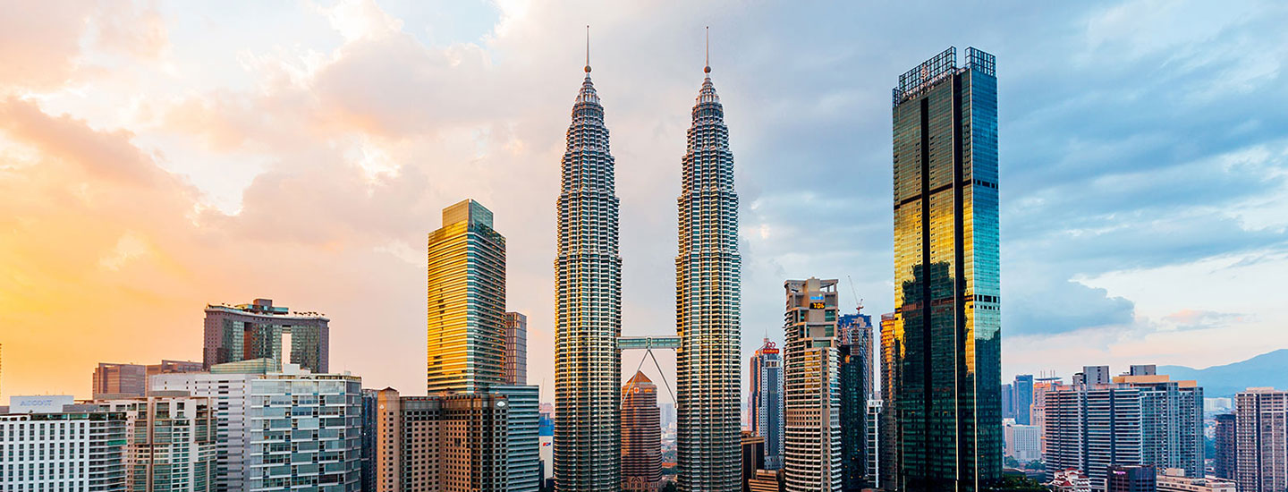 Kuala Lumpur skyline with Petronas Twin Towers and surrounding high-rises.