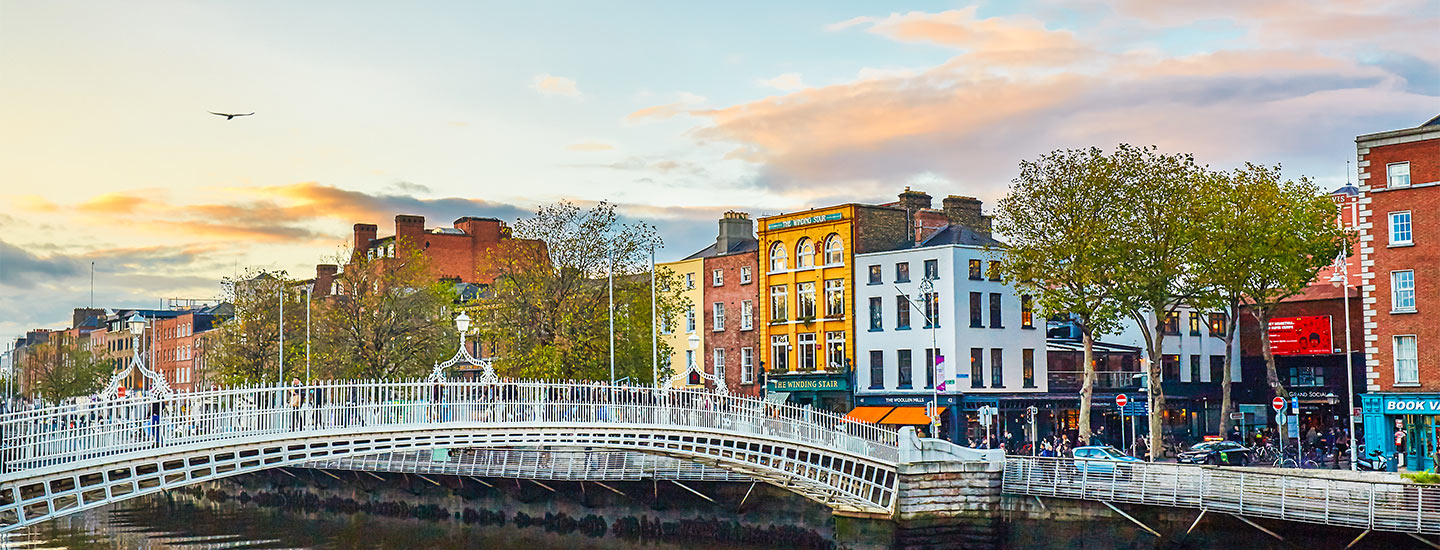 Ha'penny Bridge over River Liffey in Dublin at sunset.
