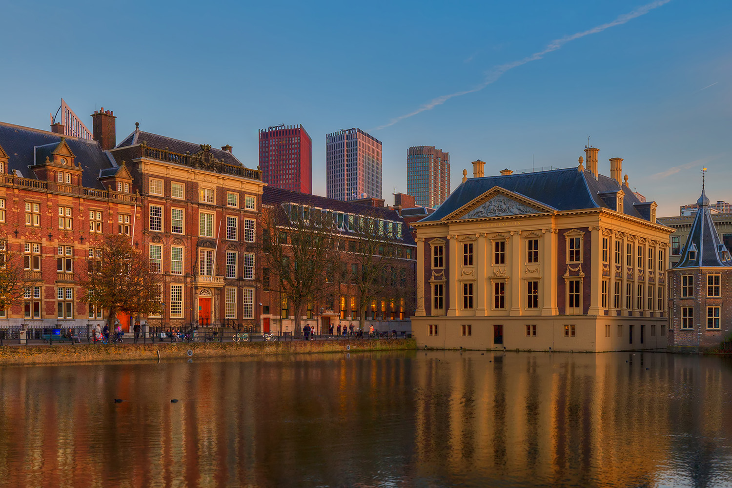 Dutch Houses of Parliament ( Binnenhof ) and Het Torentje ( The Little Tower) and the Mauritshuis reflected in the Court Pond ( Hofvijver ) and in the background Minstries of Foreign Affairs, Public Health, Social Affairs, Interior, Education in the Political center of The Hague ( Den Haag ) in the Netherlands ( Nederland )