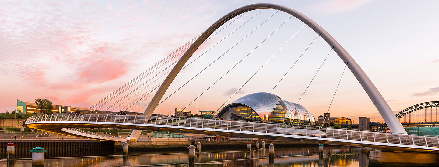 Gateshead Millennium Bridge at sunset with The Sage Gateshead in the background, Newcastle upon Tyne.
